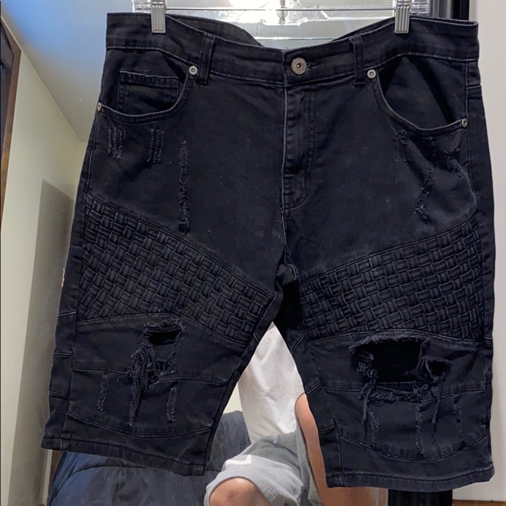 Black pair of distressed shorts